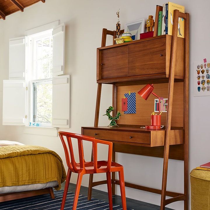 Easel mid-century modern desk next to window in art studio.