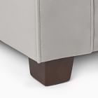Corner of sofa showing brown wooden leg
