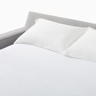 Bed with white sheets and pillows