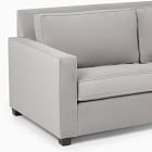 Close-up of left armrest and seat of light grey sofa