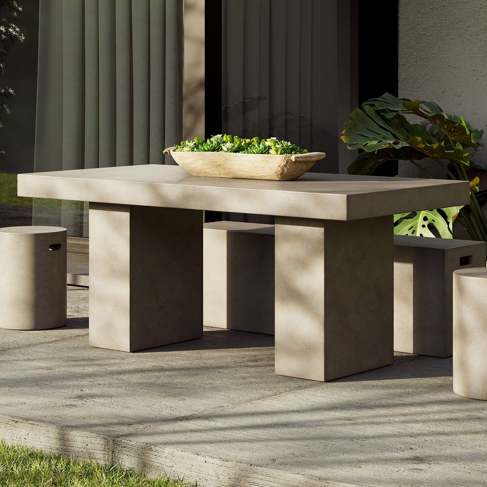 Concrete outdoor dining table with matching benches and a shallow planter on top
