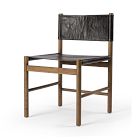 A single wooden chair with a black leather seat and backrest, minimal design