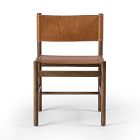 A wooden chair with tan leather seat and backrest, simple design