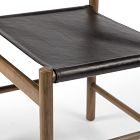 Wooden chair frame with black leather seat, close-up showing joints and legs