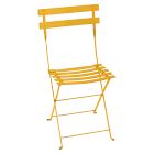 An orange/yellow metal folding chair with slatted seat and backrest