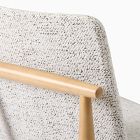 Close-up of the chair back showing textured fabric and wooden frame