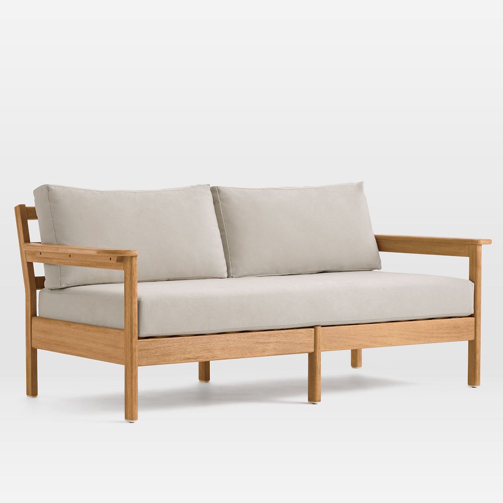 Wood-framed sofa with light cushions.