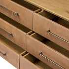 A grid of several drawers with metal handles on a wooden dresser.