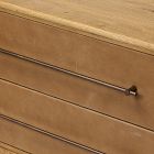 Close-up of a wooden dresser drawer rail and handle