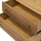 Open top drawer of a wooden dresser showing inner compartments