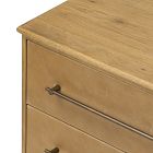 Edge of a wooden dresser with handle and front panel