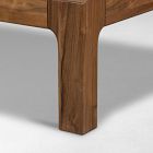 Table leg with visible wood grain and square profile resting on the floor