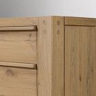 Corner of a wooden dresser showing dovetail-like joints and side panel