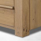 Close-up of bottom corner of wooden dresser leg and base