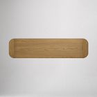 Small elongated wooden handle-less drawer front on a light wood dresser