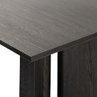 Edge and surface texture of dark wood dining table corner.