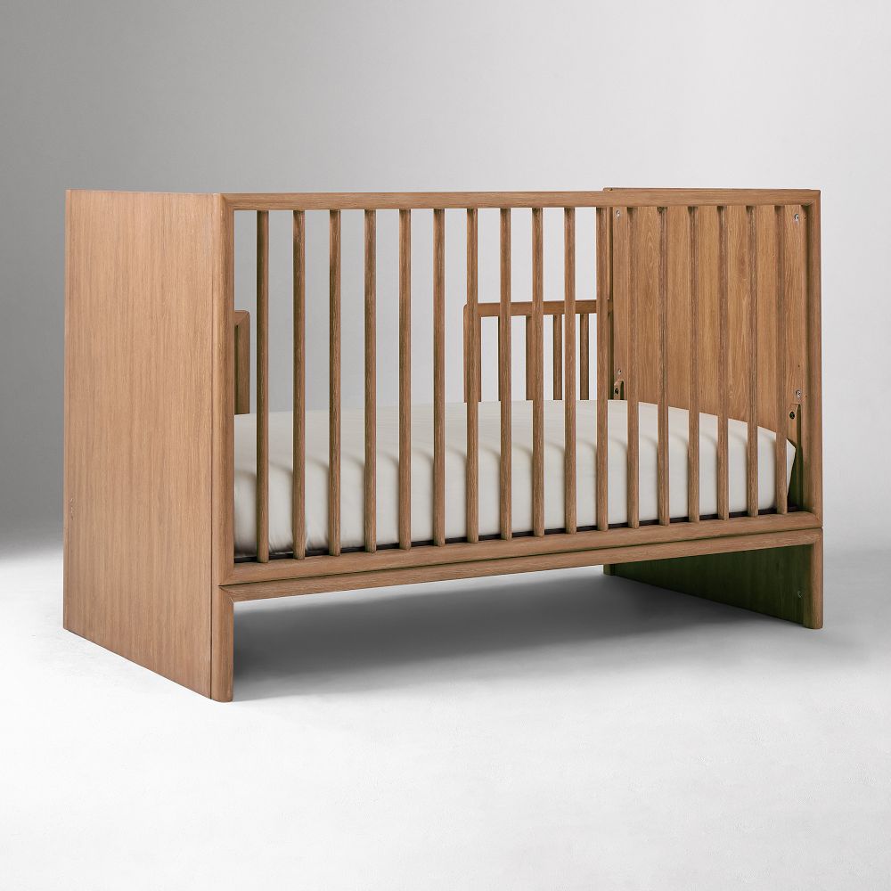 Side view of crib with guard rail folded
