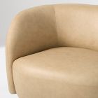 Top-left view of beige curved-arm sofa showing cushions and edge