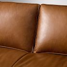 Two tan leather sofa cushions with visible seam lines.