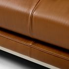 Stitch seam along a tan leather sofa seat cushion.