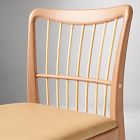 Close-up of the curved top of chair back with vertical slats.