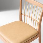 Cushioned seat and chair back in a close-up.