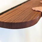 Shelf being installed with hand on surface