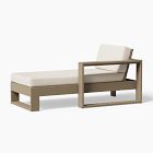 Two-piece outdoor lounging set: long ottoman on left and lounge chair on right, beige cushions.
