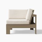Lounge sofa with beige cushions, corner/back view, and wooden frame.