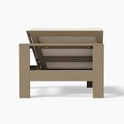 Backside view of a wooden sofa frame with slatted seating pieces.