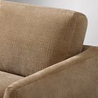 Close-up of tan fabric upholstery on a sofa, highlighting texture.