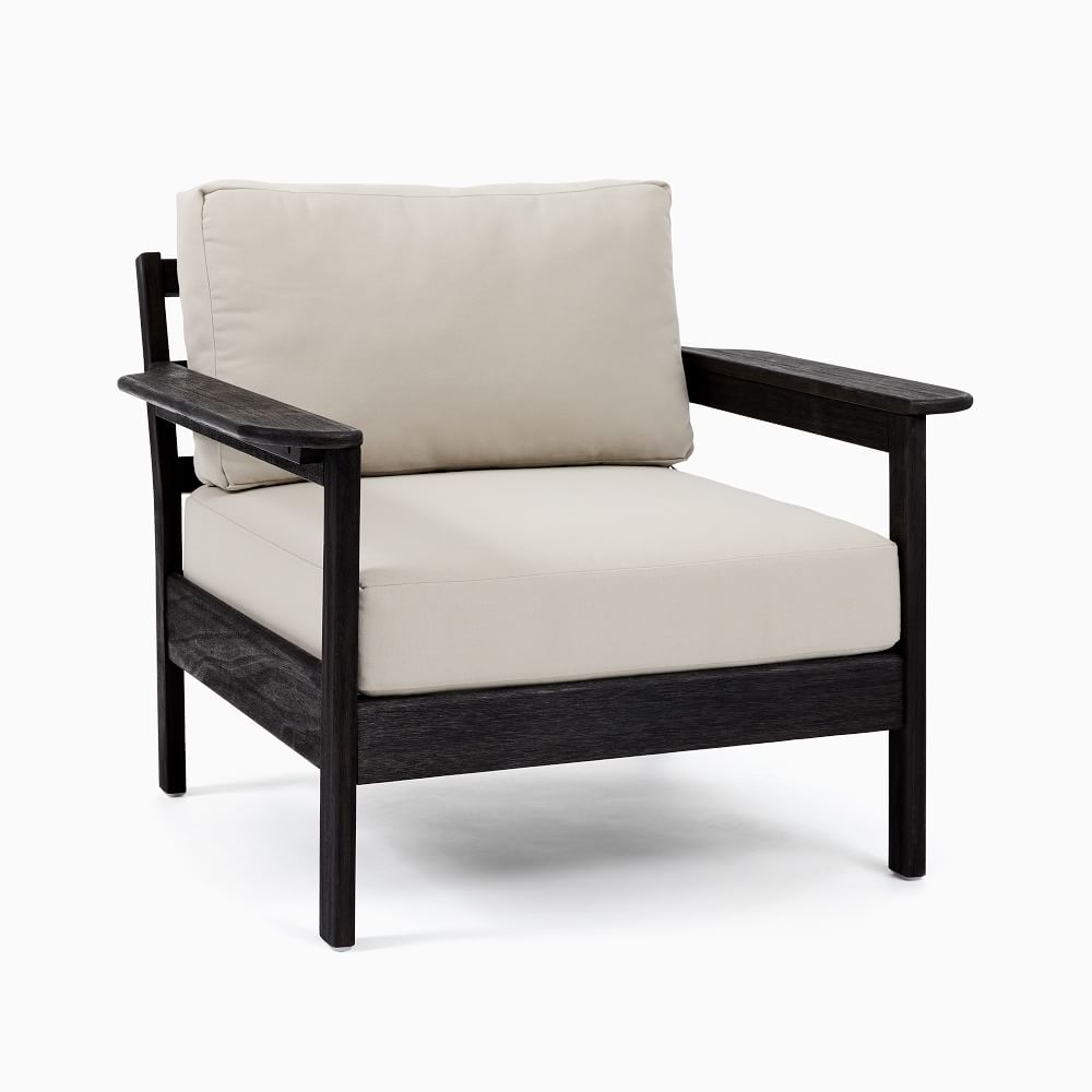 Dark stained armchair with beige cushions.