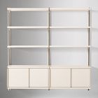 Full modular storage wall with open shelves on top and multiple closed drawers at the bottom in a pale wood finish.