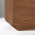 Rounded wooden vanity corner with curved bottom and small knob drawer pull.