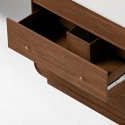 Close-up of bottom drawers of a wooden vanity showing internal compartments and drawers.