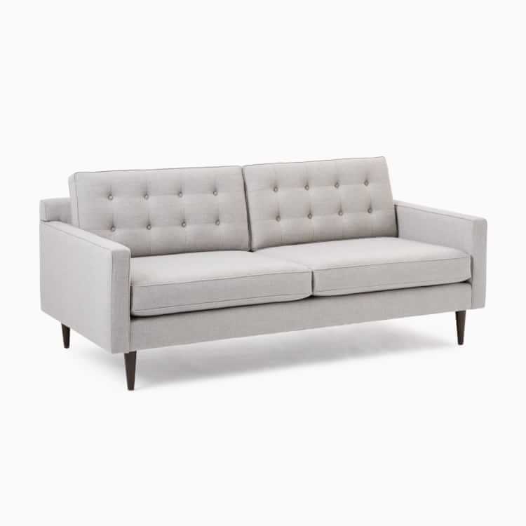 Light gray fabric sofa with tufted back
