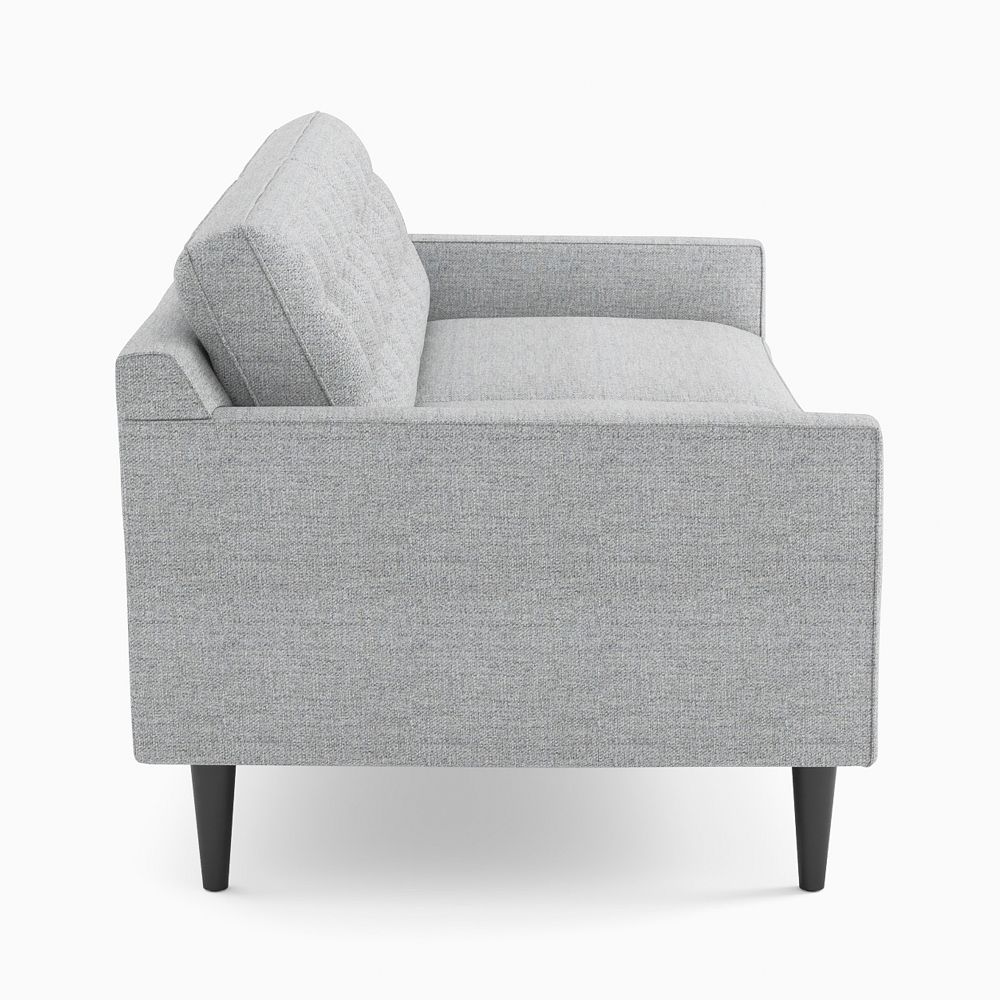 Side view of gray tufted sofa