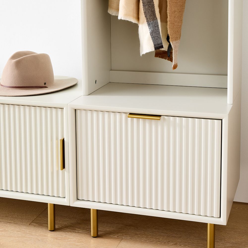 Beige hat resting on top of cabinet with drawers