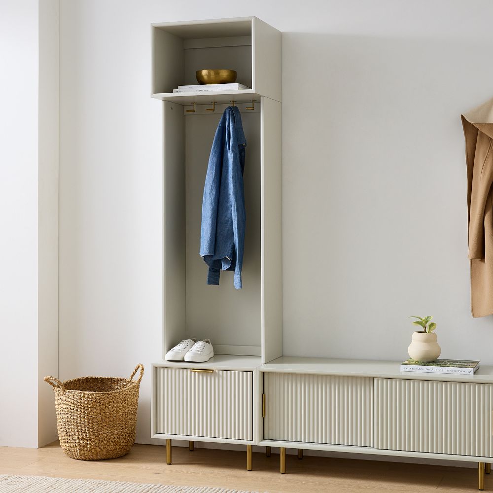 Tall wardrobe unit with a denim shirt hanging