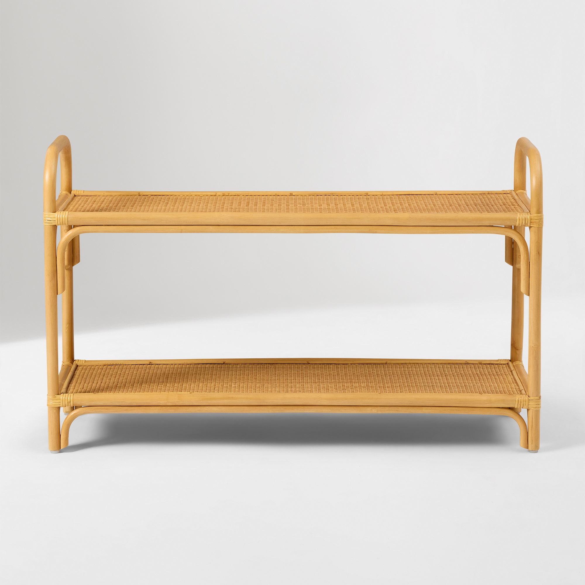 Curved rattan small shelf standalone against white background