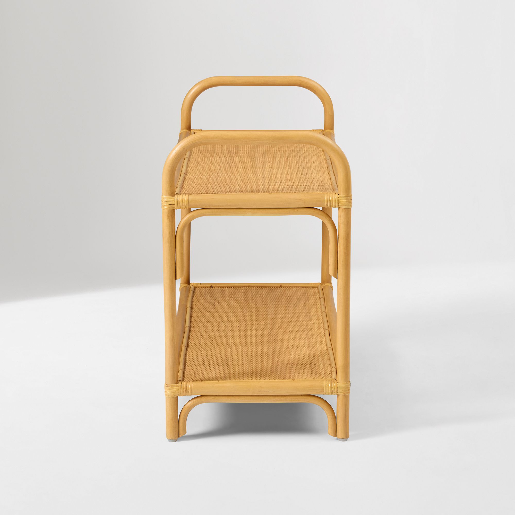 Front view of curved rattan small shelf