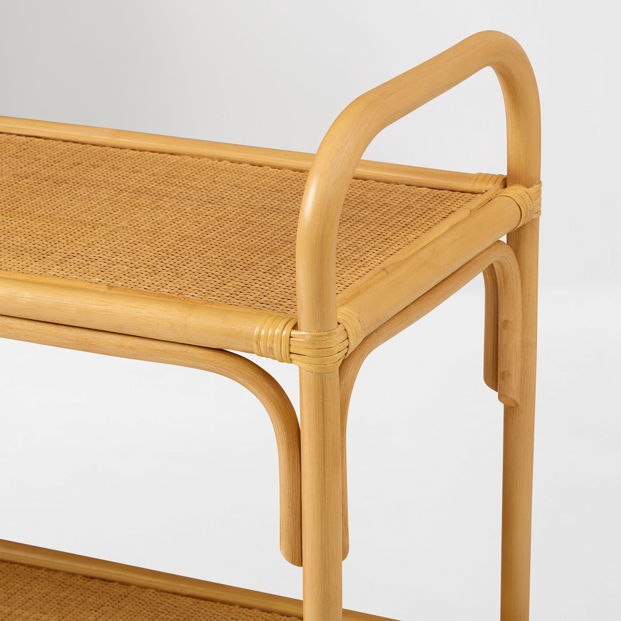 Corner detail of curved rattan small shelf showing weaving and joints