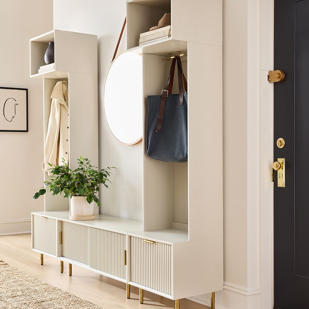 Entryway storage unit with coat, bag, mirror, and potted plant