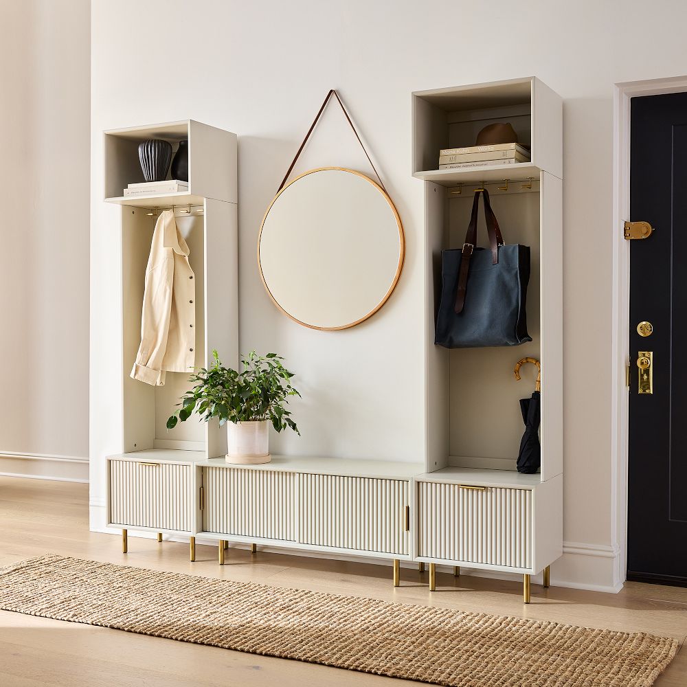 Entryway unit with large round mirror and hanging coats