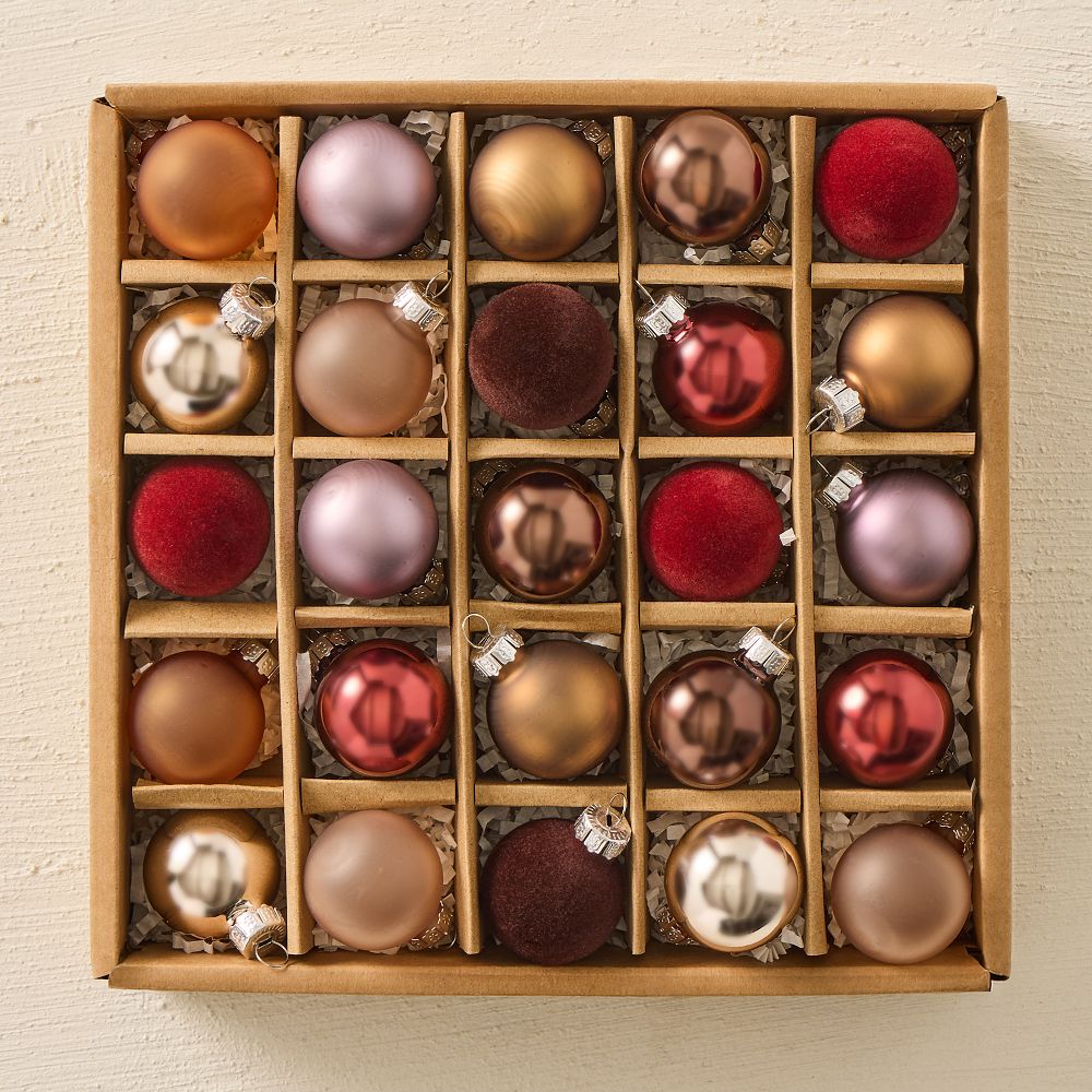 A box of small glass ornaments in copper, mauve, gold and deep red