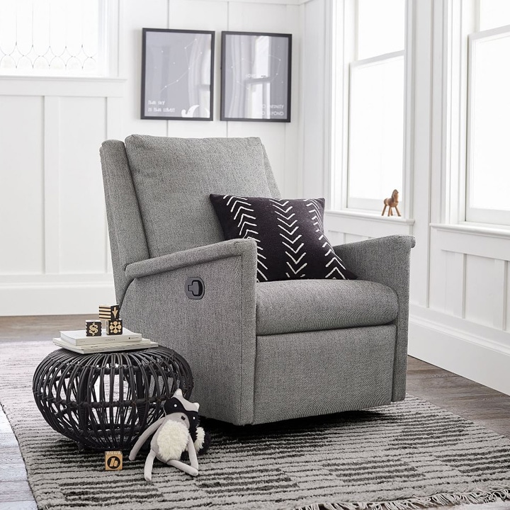 Gray swivel recliner with black pillow.