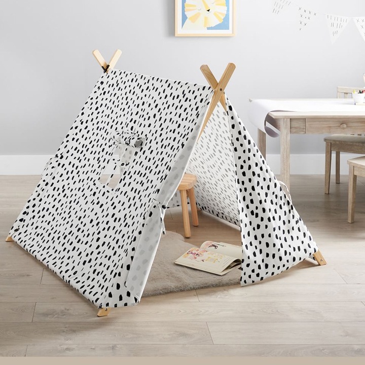 Black and white play tent with book inside.