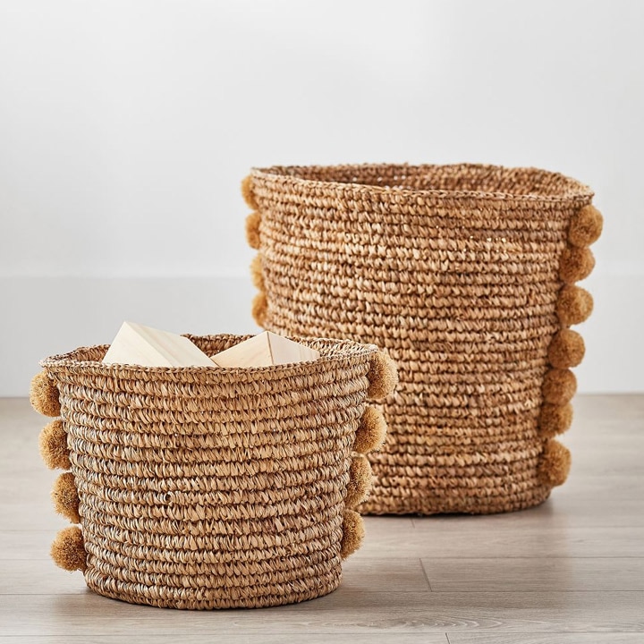 Storage baskets with pom poms.