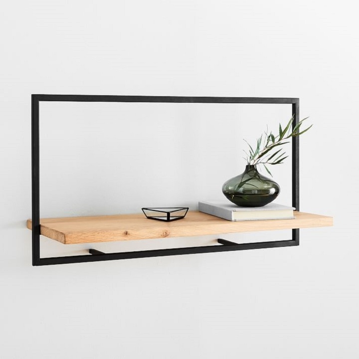 Black modern shelves displaying books, pictures and decor 
