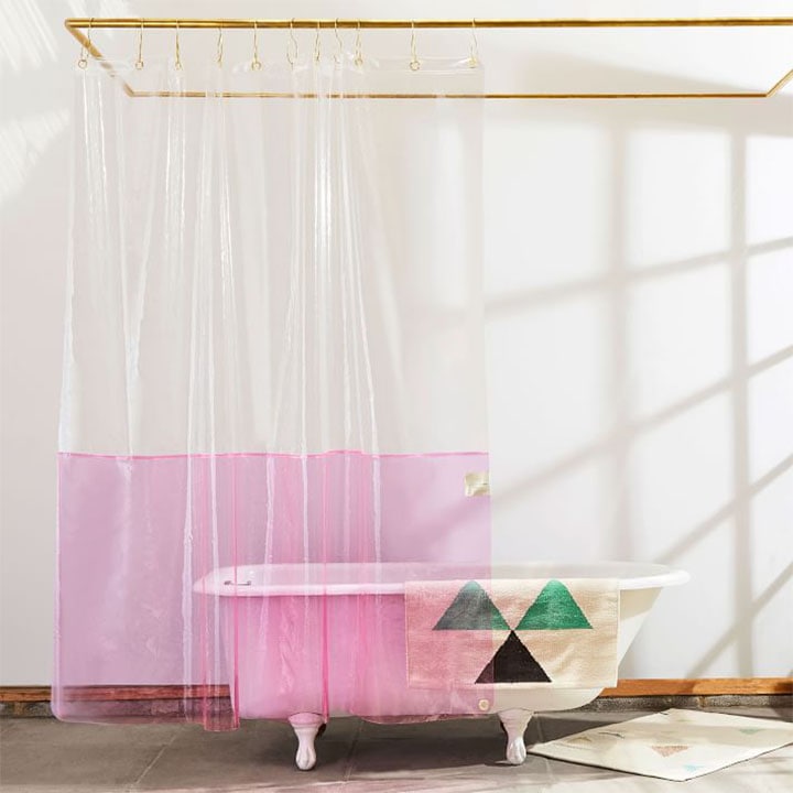  bath tub and shower curtain with pink accents